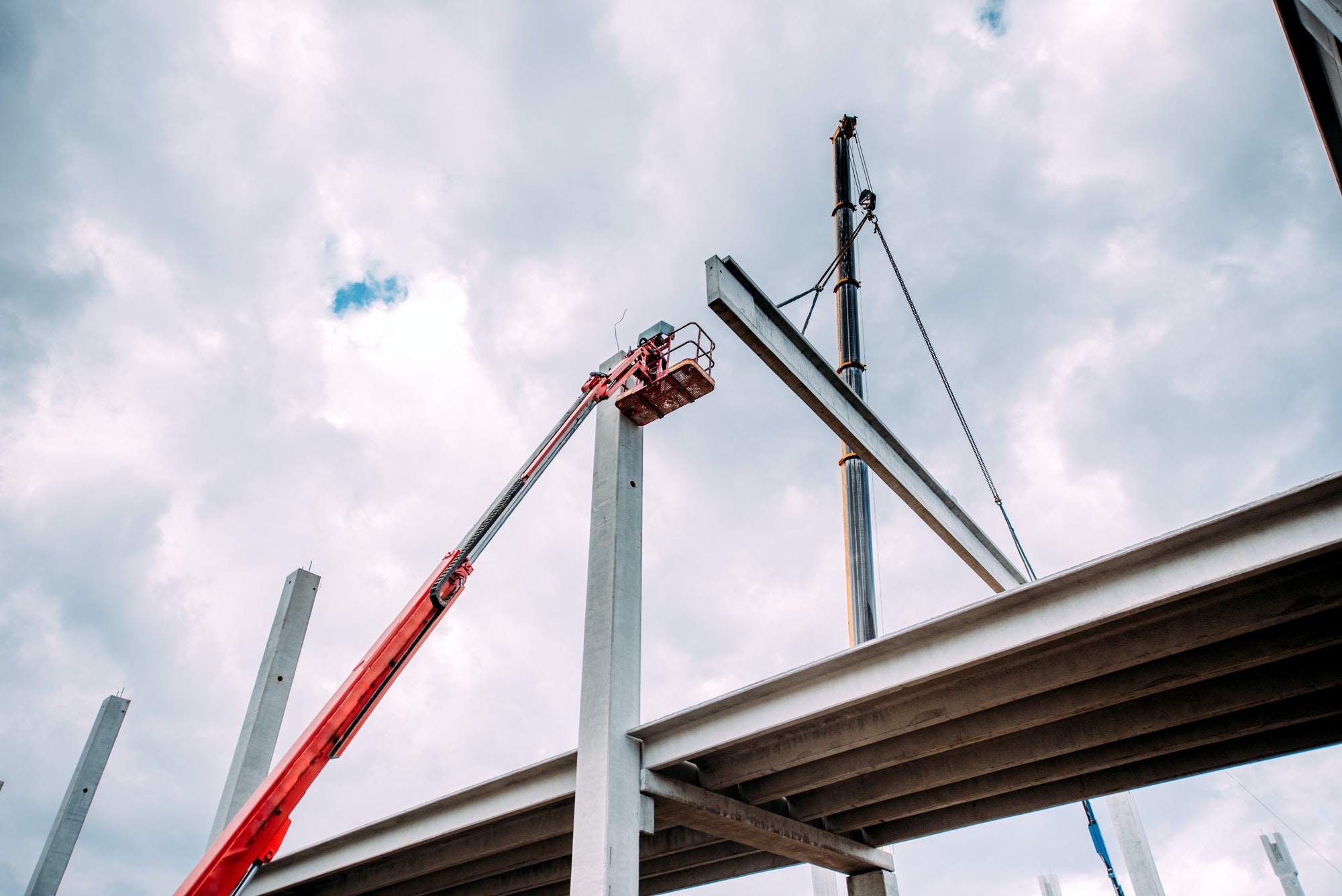 Details of construction site with crane lifting prefabricated concrete framework