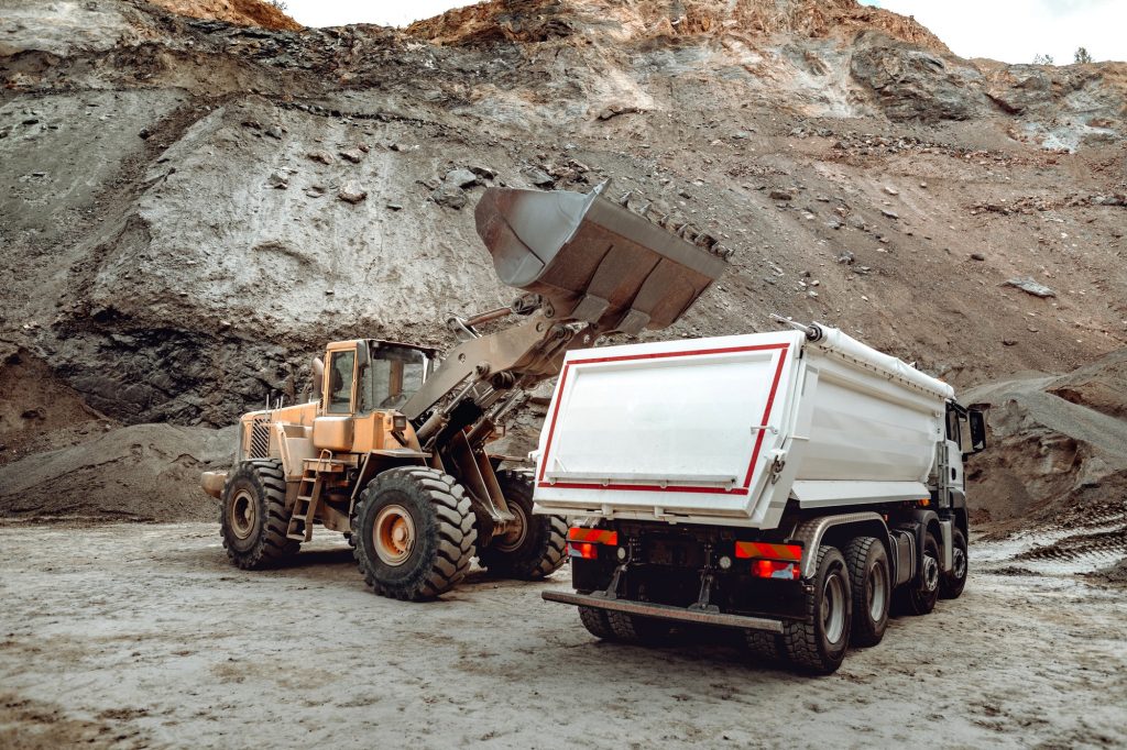 Industrial dumper trucks and wheel loader bulldozer working on highway construction