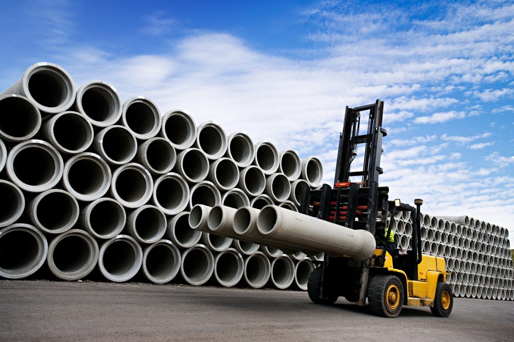Stacked Concrete Pipes and Forklift